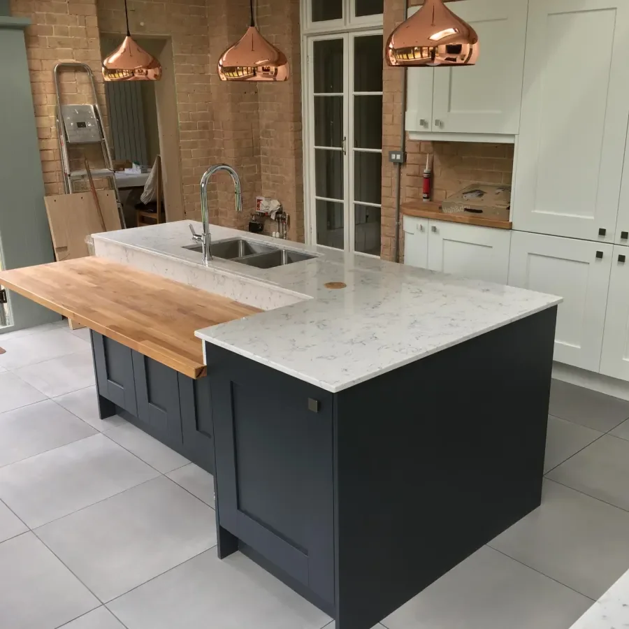 A kitchen island with copper pendant lights fitted by TF Fitting & Installation